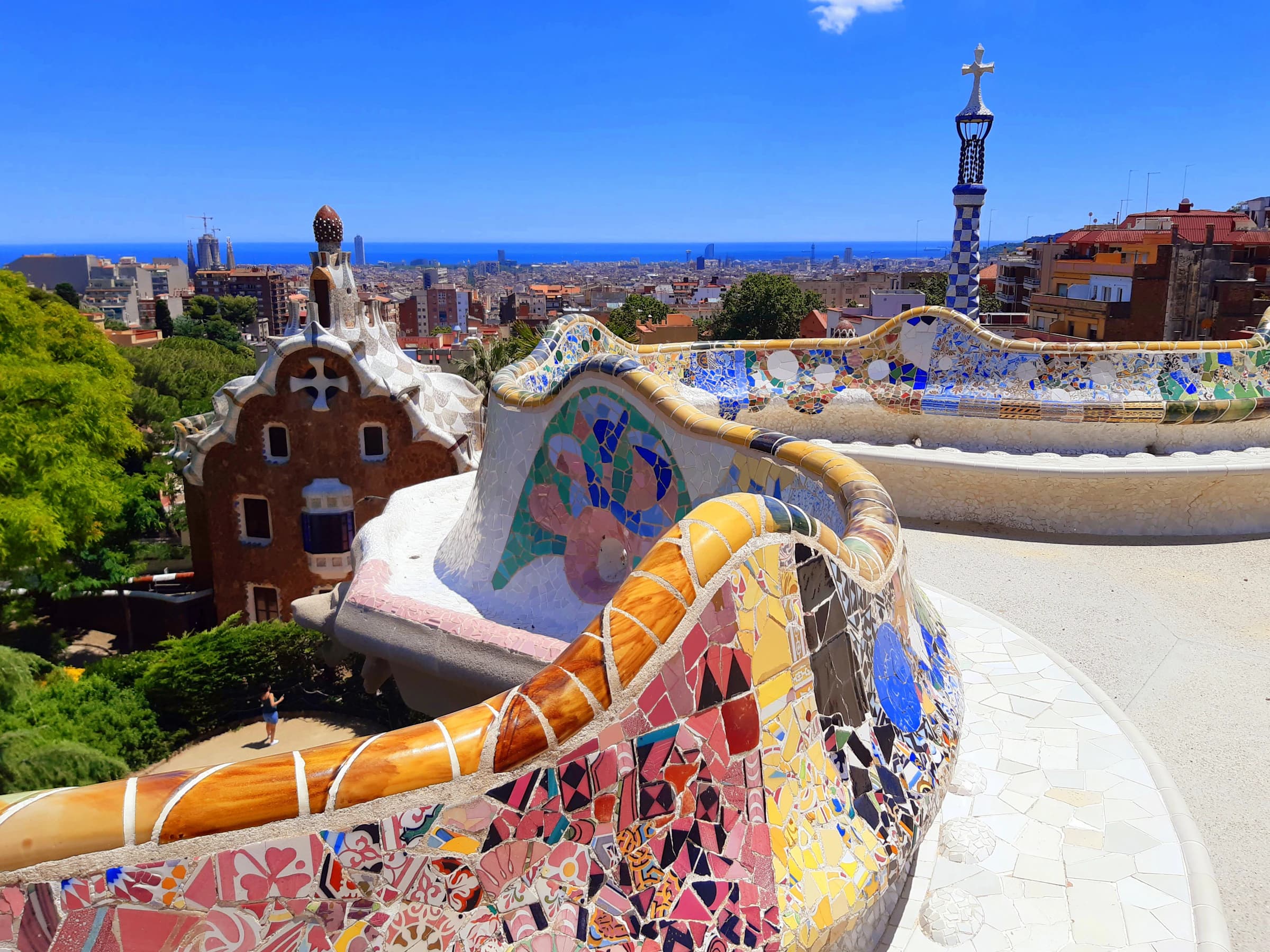The winding mosaic bench and entrance pavilions at Park Güell
