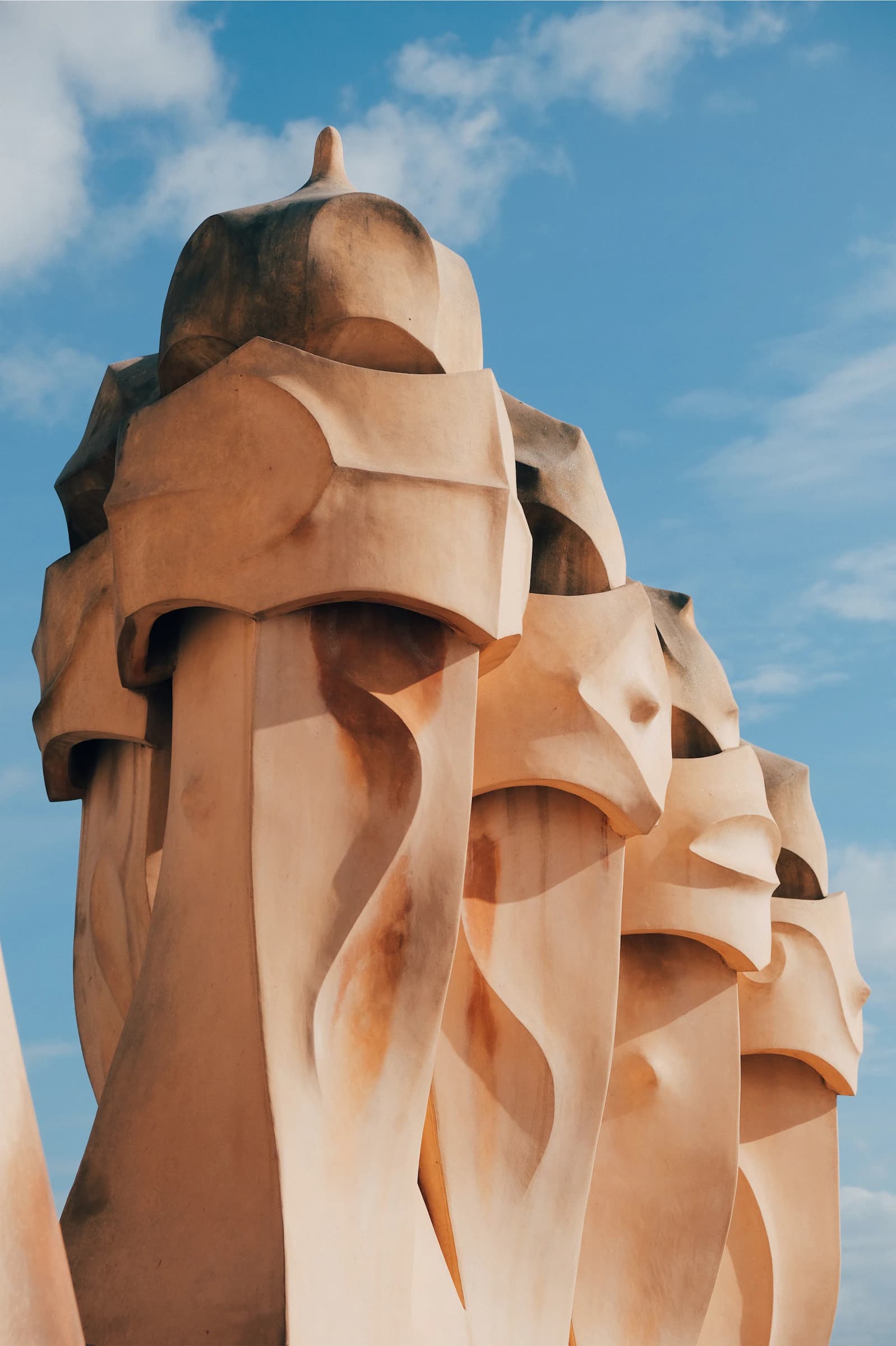 A sculptural chimney on Casa Milà’s rooftop against the sky
